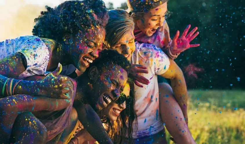 Diverse group of people with paint splattered all over them