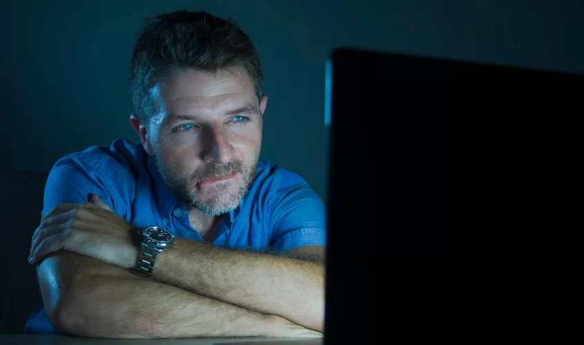 Man sitting down with laptop open