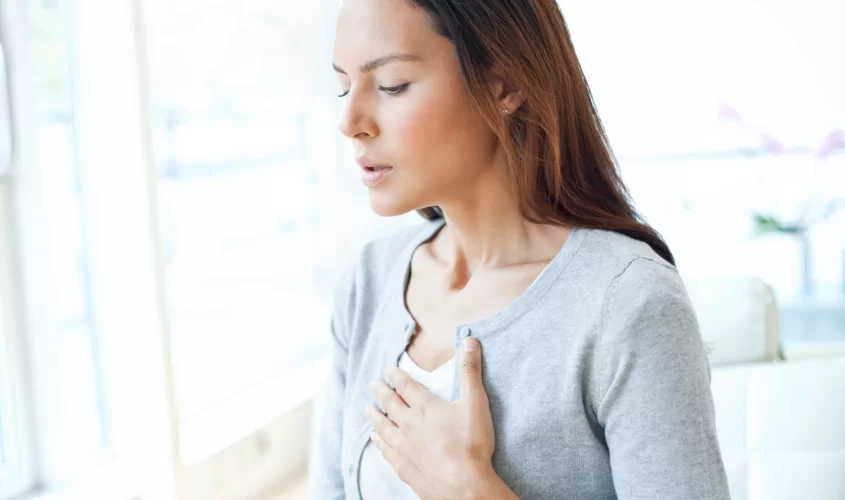Woman with hand to chest, symbolizing panic