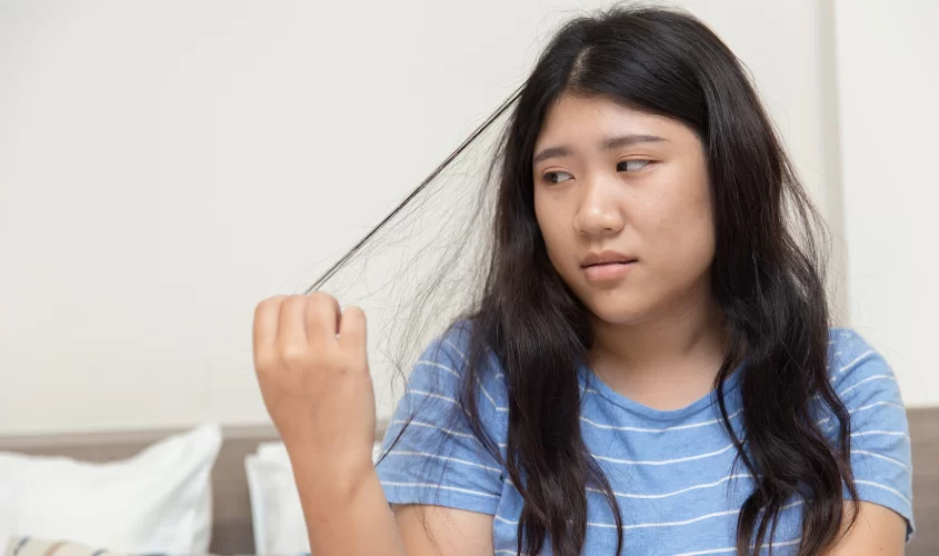 Woman pulling at hair