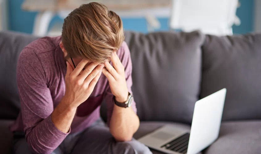 Man on couch with head down