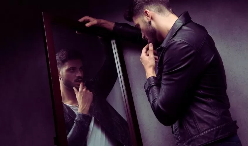 Man looking at self in mirror