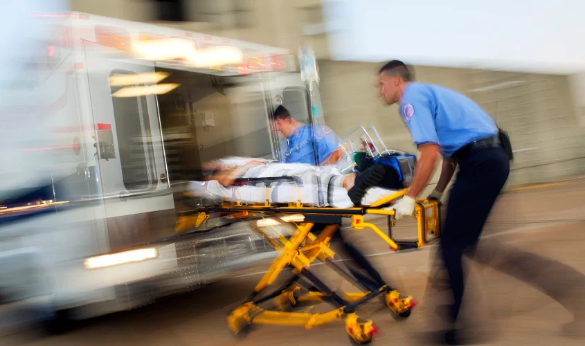 Emergency responders putting someone in the back of the ambulance
