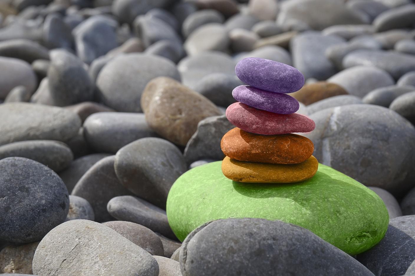 stacked coloured stones among grey stones