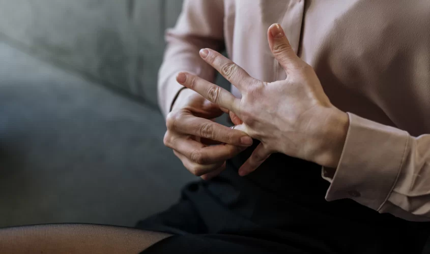 Woman taking off wedding ring