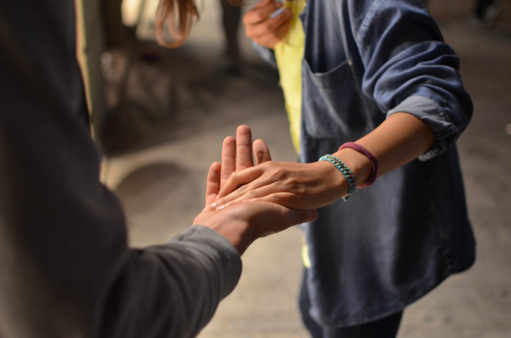 Men touching each others hand to support each other.