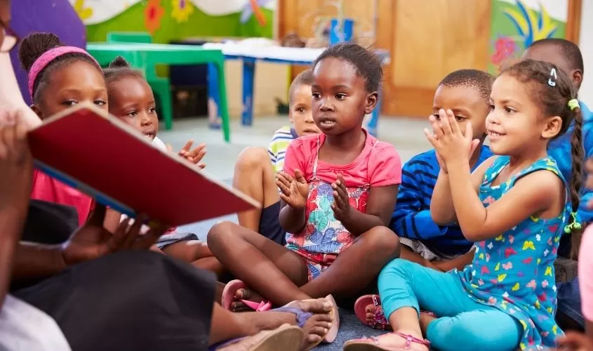 Children listening to a book getting read to them