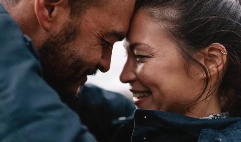 Happy Couple hugging each other and touching foreheads