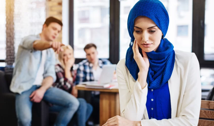 Women feeling discriminated by other work members behind her