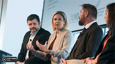 Four corporate leaders sitting down discussing mental health