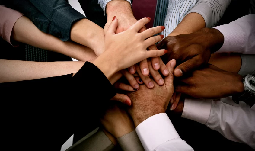 Group hand huddle, symbolizing teamwork and group collaboration