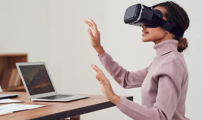 Girl using VR at a desk.