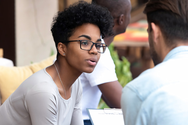 Two individuals talking in a public space