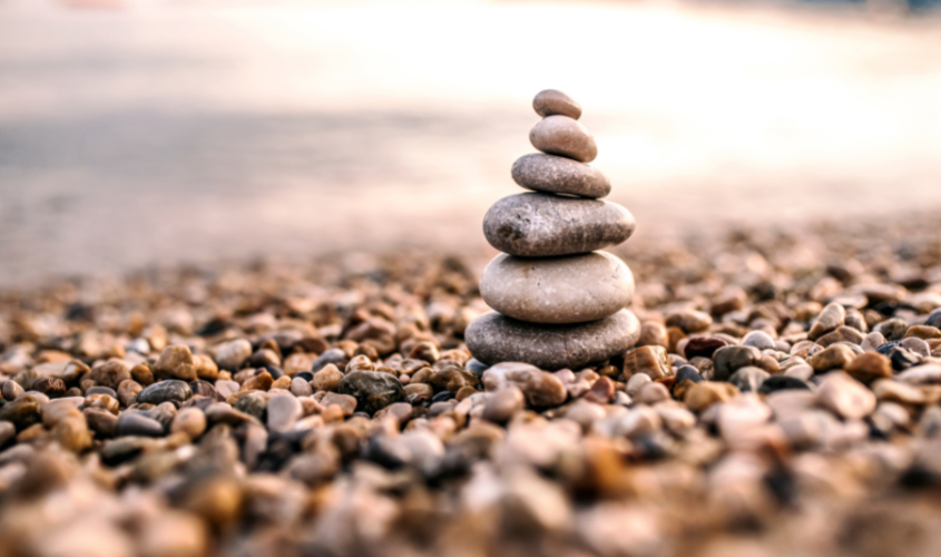 Small rocks covered on ground with larger rocks built up on top of each other