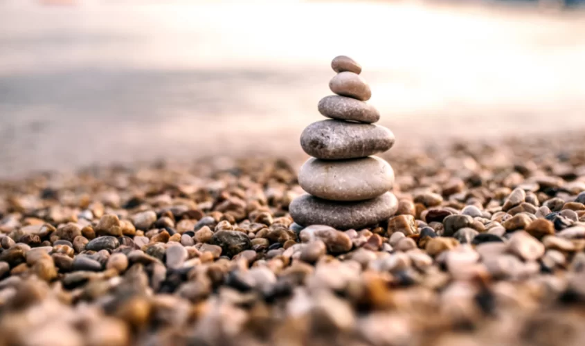 Small rocks covered on ground with larger rocks built up on top of each other