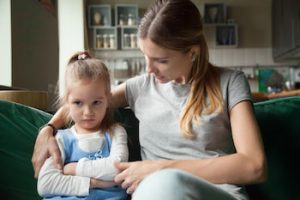 Mother consoling with upset kid daughter who is dealing with big change