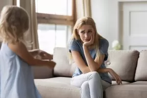 A child wanting to her mom who does not look impressed or want to