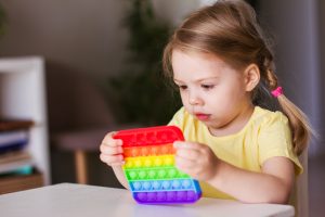 Little,Blonde,Girl,Children,Play,With,New,Trend,Sensory,Toy