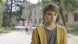 Teenage school boy standing alone without any friend