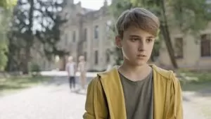 Teenage school boy standing alone without any friend