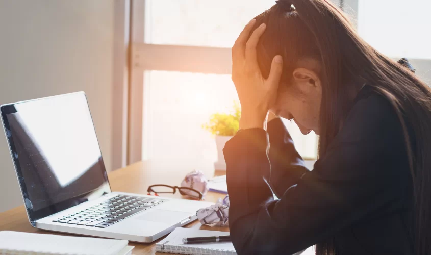 Women stressing over her work on the computer. 