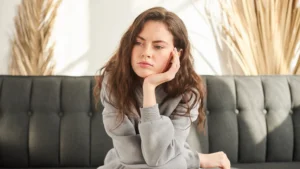 Women Sitting on a Black Couch Looking Upset