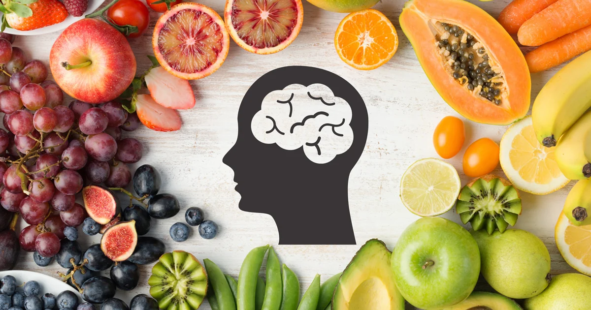 A brain silhouette surrounded by fruits and vegetables, representing gut health and mental health.